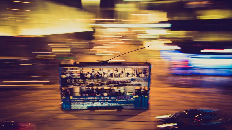 double decker bus in motion moves through the night on hong kong island, bus in motion hong kong 4k
