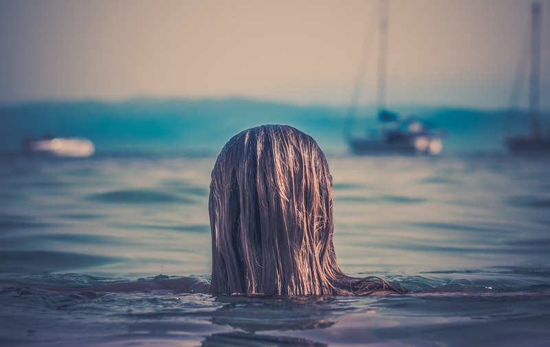 womans long hair head above the water at banana beach, womans head above the water 4k