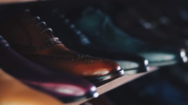 various leather boots and shoes lined up on a shelf, leather shoes and boots 4k