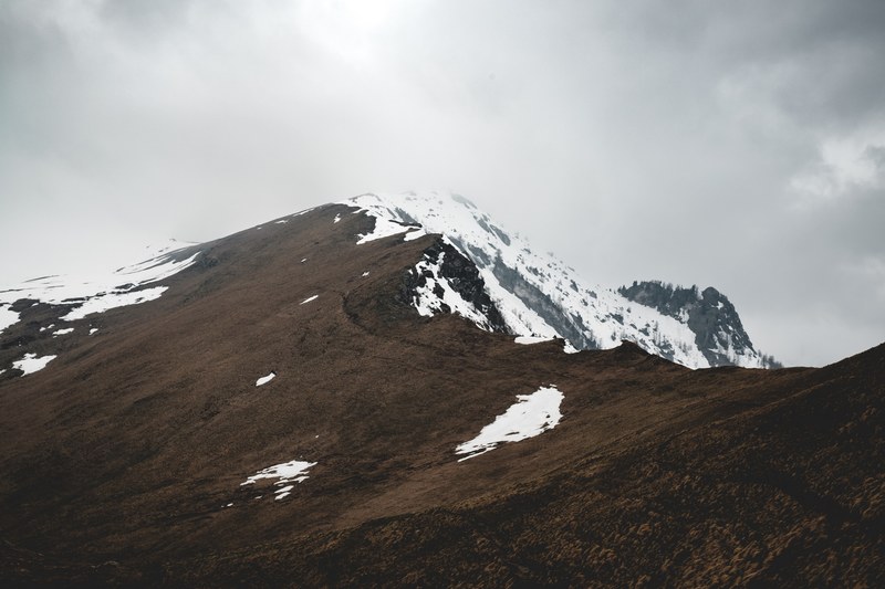 a snowy mountain mixes with a cloudy overcast sky, after a long time 4k