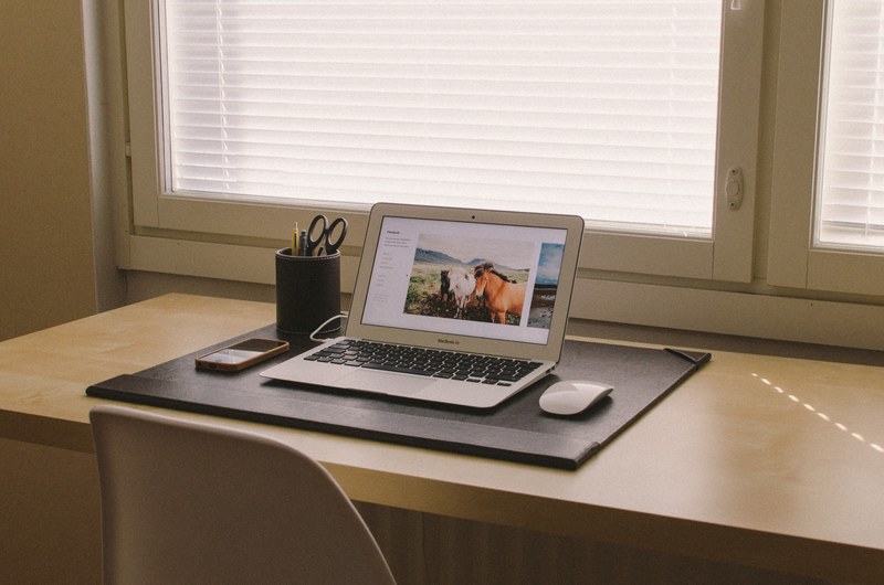a clean office environment showing an apple macbook laptop computer and iphone on a desk, _apple laptop on a desk 4k