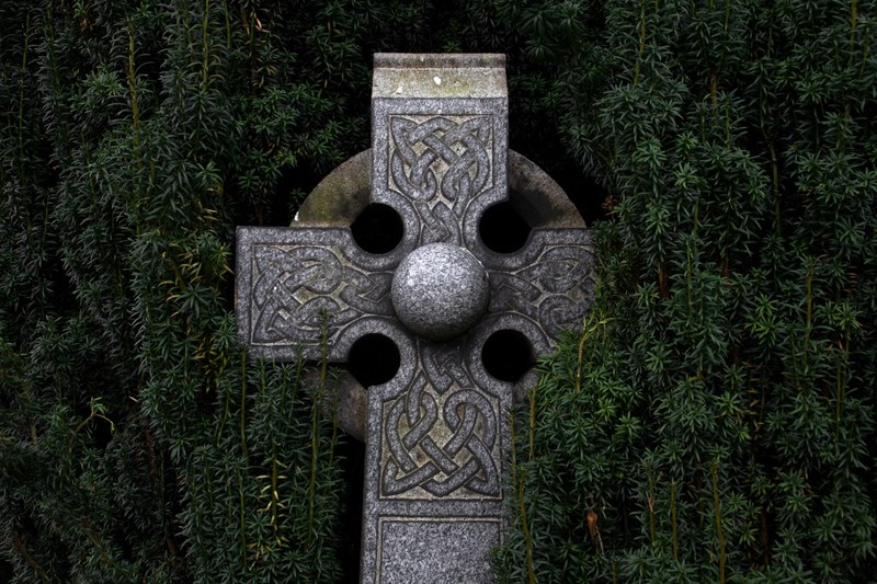 celtic cross grave hole and greenery 4k