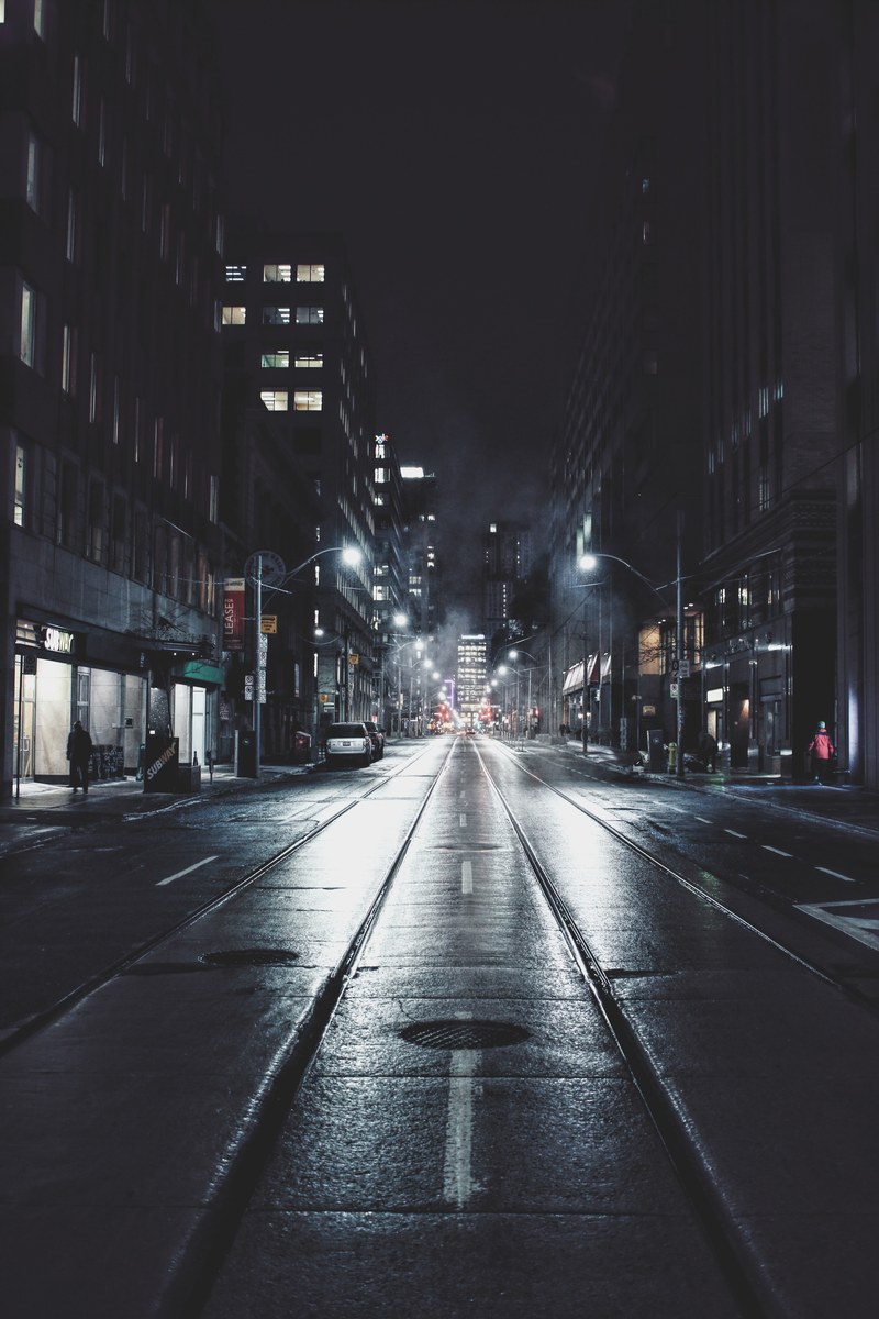 street views on a dark rainy night in downtown toronto, glistening pavement 4k
