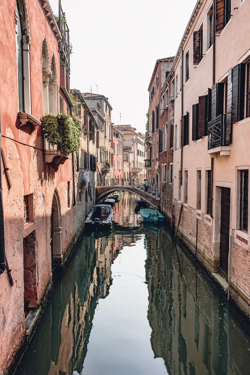 canal in venice italy with houses lining the canal, magic around every corner 4k