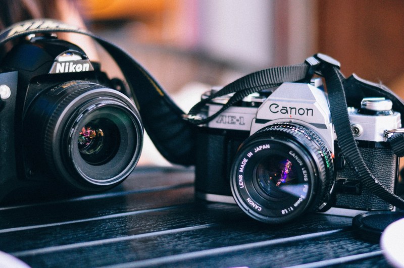 canon and nikon cameras on a table, photographers equipment 4k