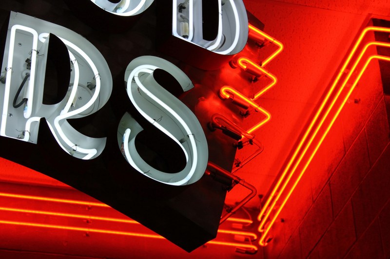 details of lettering on vintage neon sign glowing orange, neon lights 4k
