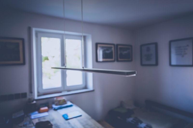 ceiling lamp hangs down in an empty room with a table, table in workroom 4k