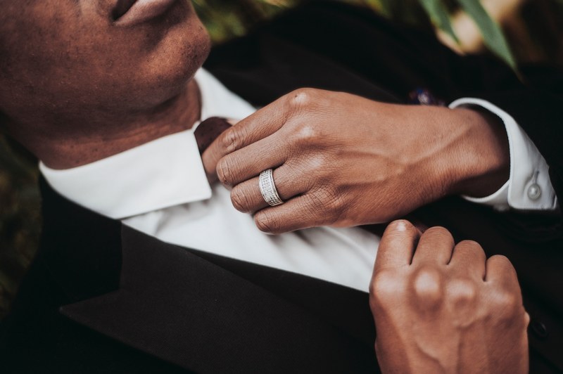 groom adjusts his tie against white shirt and black suit, wedding tie adjustment 4k