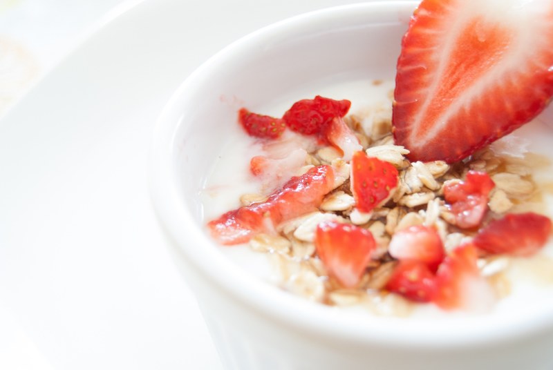 a cup of yogurt with granola and fresh strawberries, fruit and yogurt 4k