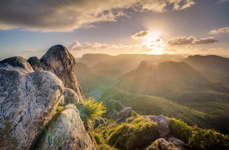 sun shines over a lush green mountainside, green mountain landscape 4k