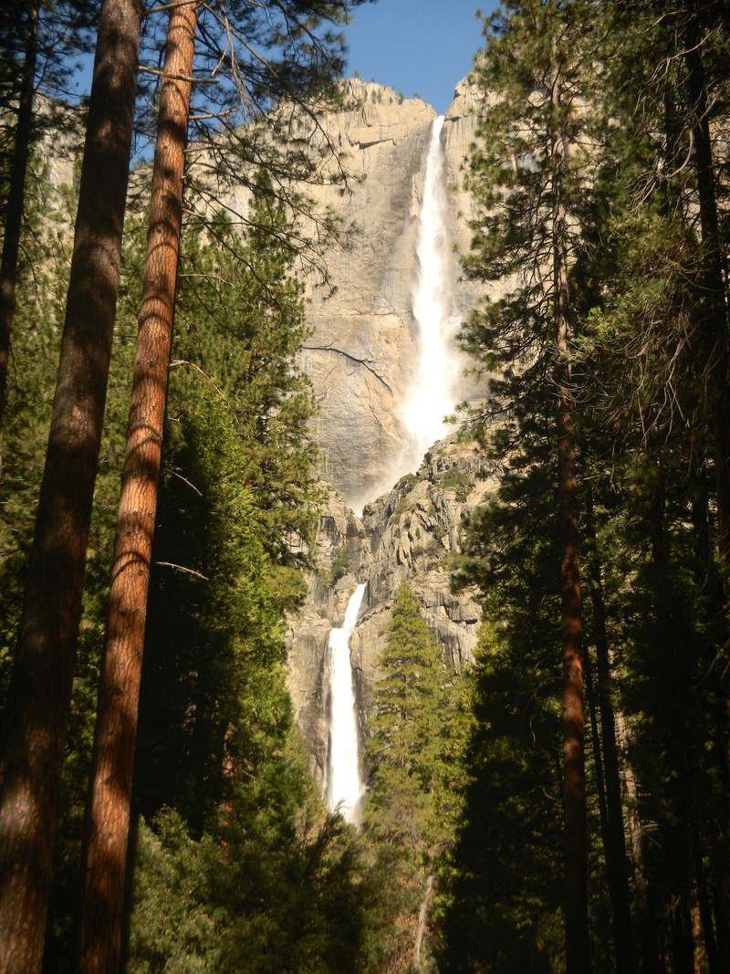 a look up at a waterfall pouring down a rocky mountain in yosemite national park, waterfall on yosemite cliff 4k