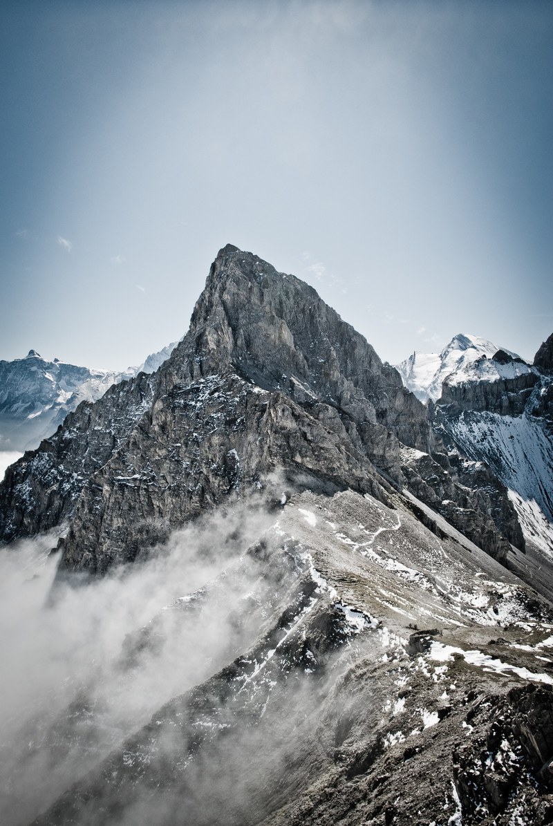 misty fog wraps around snowy mountain at bunderspitz, fog on bunderspitz mountain 4k