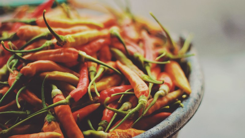 bowl of yellow and red spicy chili peppers, spicy vegetables 4k