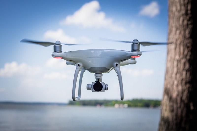 drone camera hovering mid flight outside, drone at work 4k