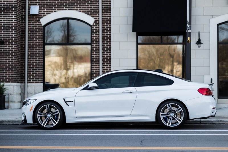 a luxurious white bmw car parked on the side of a street, white bmw by the sidewalk 4k