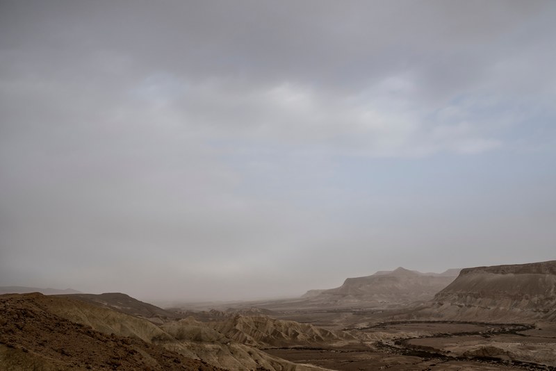 gray clouds hide the sky over the barren desert plains, negev desert 4k