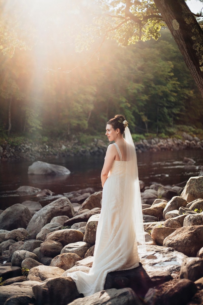 bride poses on rocks by the waters of shelburne falls, bride poses at shelburne falls 4k