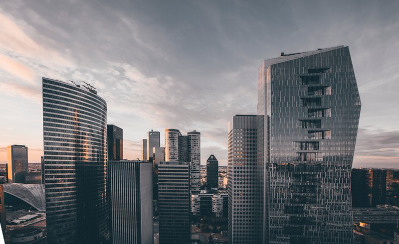 panoramic shot of a city skyline with modern skyscrapers at daybreak, _sun reflection in high rises 4k