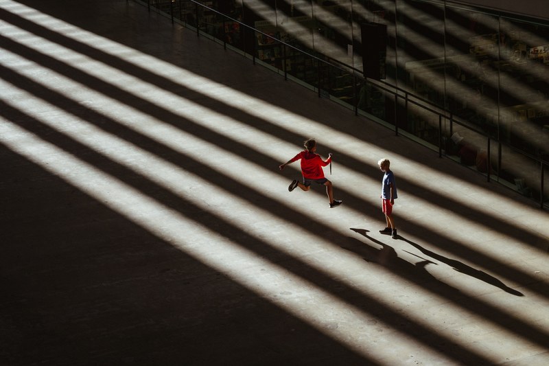 kids jump and play in the shadows of an empty arena, kids 2017 4k