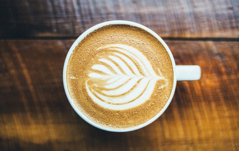coffee in a cup with latte art in the milk in lancaster, lancaster latte art 4k