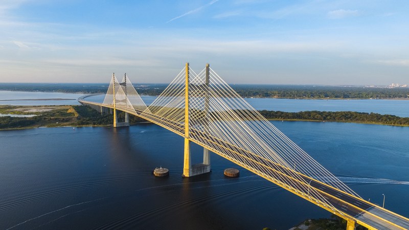 two lane road on a long bridge over a wide river, long bridge 4k