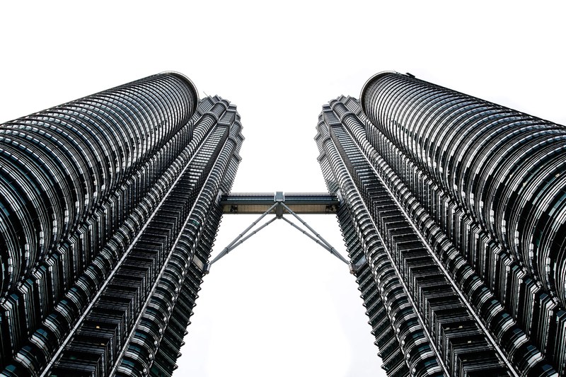 the twin towers of the petronas towers complex connected with a skybridge, twin towers in malaysia 4k