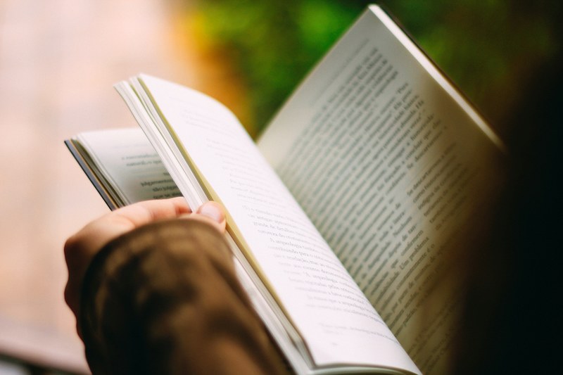 a person leafing through a book, leafing through a book 4k