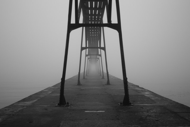 foggy view of a steel bars on a pier near the ocean, foggy pier 4k