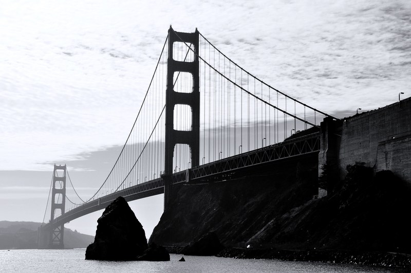 black and white shot of golden gate bridge in san francisco from afar with cloudy sky, monochrome golden gate 4k