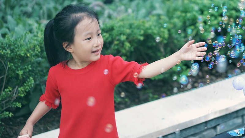 a little girl wearing a red sweater playing with bubbles, my girl 4k