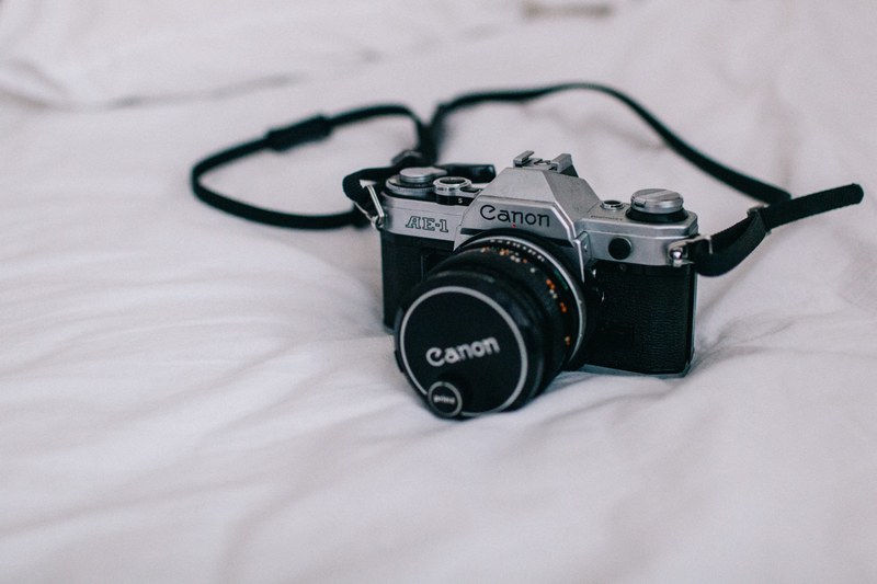 vintage film canon camera on a bed, photographers bedroom 4k