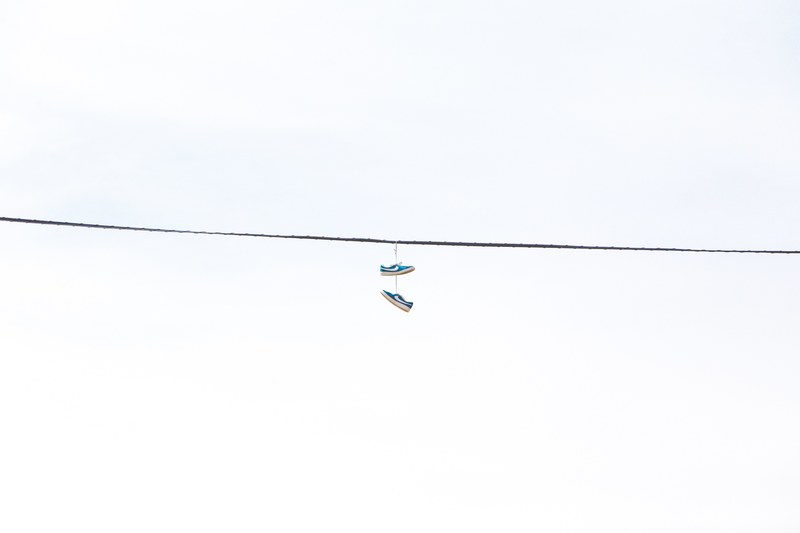 a pair of shoes hanging from a power line, shoes on line 4k