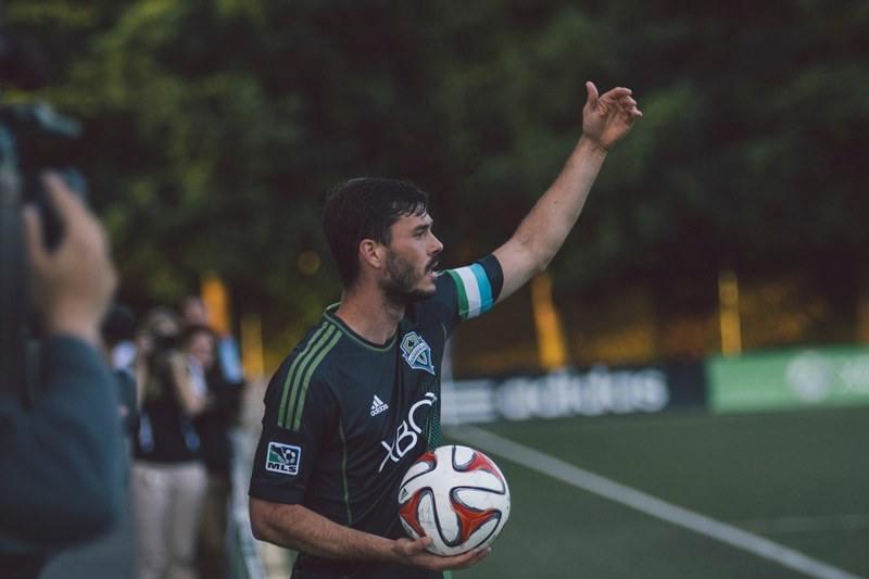 a man with a soccer ball in his hand preparing to throw the ball in, soccer throw in 4k