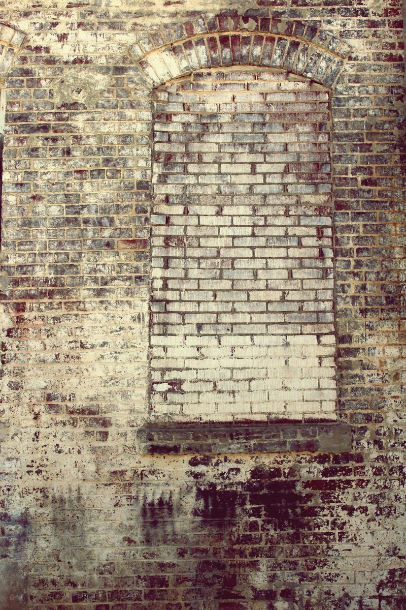 a brick building with bricks covering the opening where a window once was, _bricks over window opening 4k