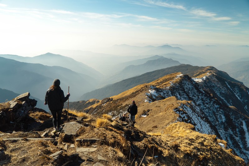 hikers walk a rocky path on mountain ridges, adventurous mountain hikes 4k