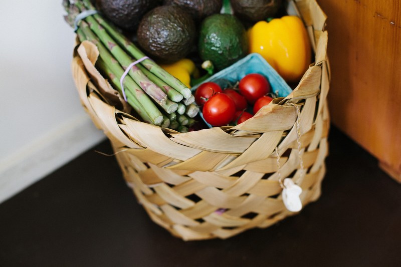 basket of fresh produce with tomatoes avocados peppers and asparagus, healthy grocery shopping 4k