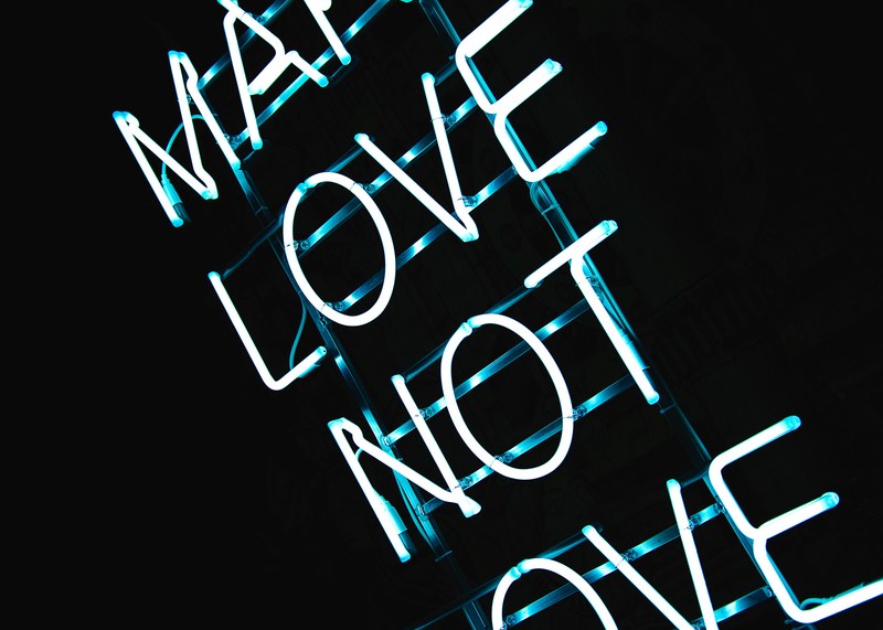 blue neon light sign on black background reads make love not love, make love neon sign 4k