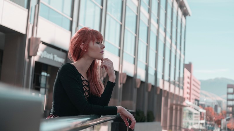 a red headed woman leaning against a railing, red headed woman at a railing 4k