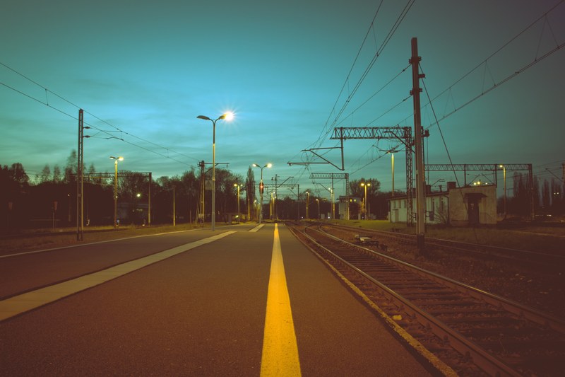 a view from the side of the street near a railway platform, outside near railway station 4k