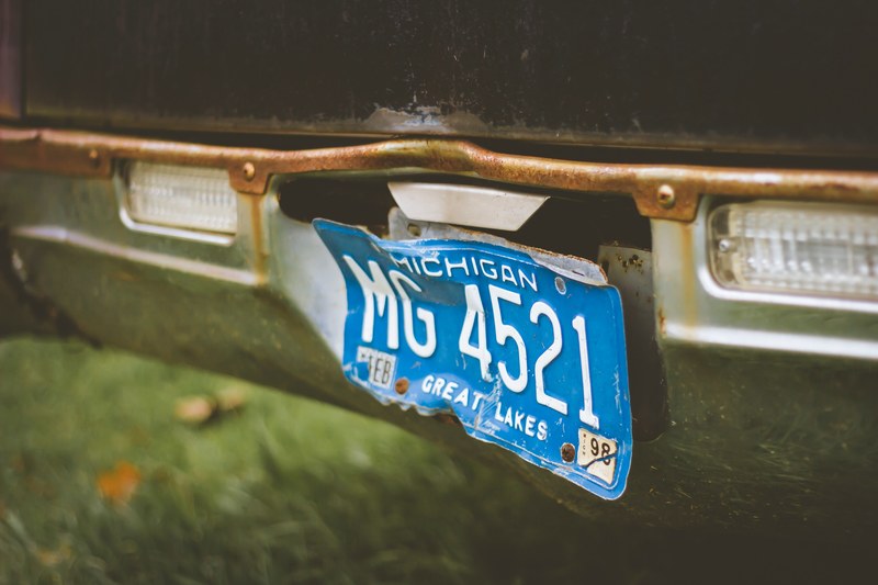 close up of vintage broken blue michigan license plate in ashley, vintage license plate in ashley 4k