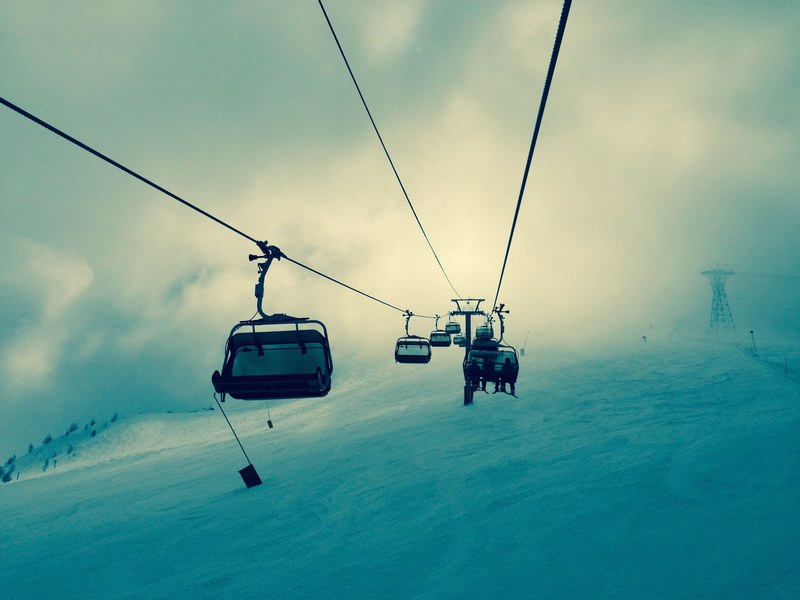 dangling feet going up a ski lift on a cold winter day, dangling on the ski lift 4k