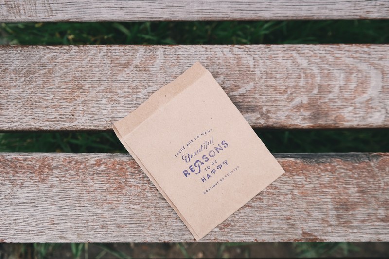 a piece of brown stationery on a wooden bench, stationery on a bench 4k