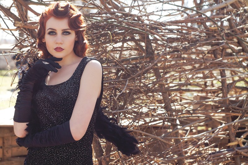 woman in dark makeup with a vintage hairdo and retro outfit, vintage costume 4k