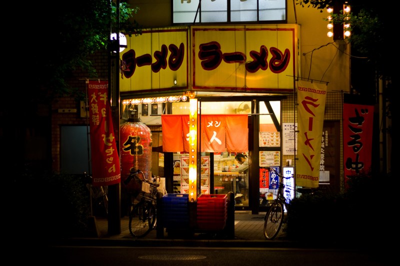 storefront of an asian restaurant at a city market at night, asian market 4k