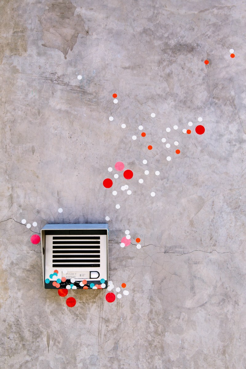 polka dot graffiti art work on textured urban wall and speaker in milan, polka dot graffiti in milan 4k