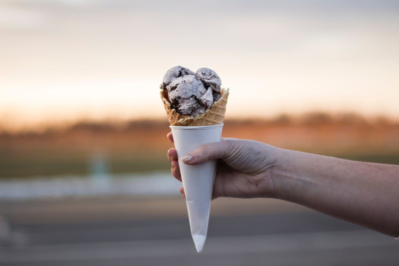 hand holding scoops of sweet ice cream in a cone, ice cream dessert 4k