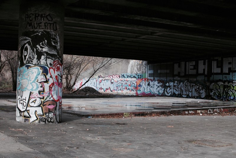 creepy underpass covered in graffiti on a dark rainy day in hackney marshes, underpass covered in graffiti 4k