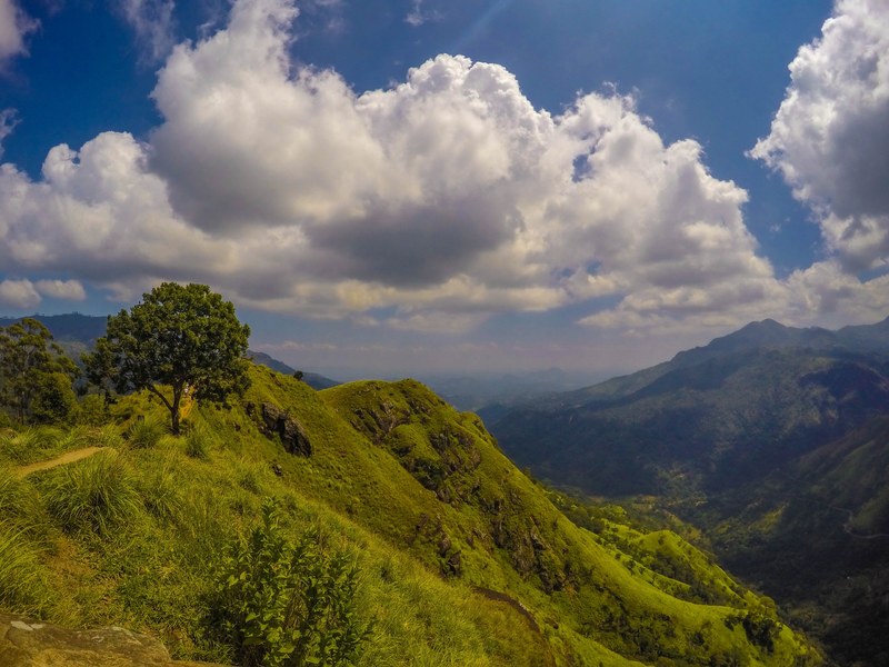clouds over a deep green mountain valley, deep green valley 4k
