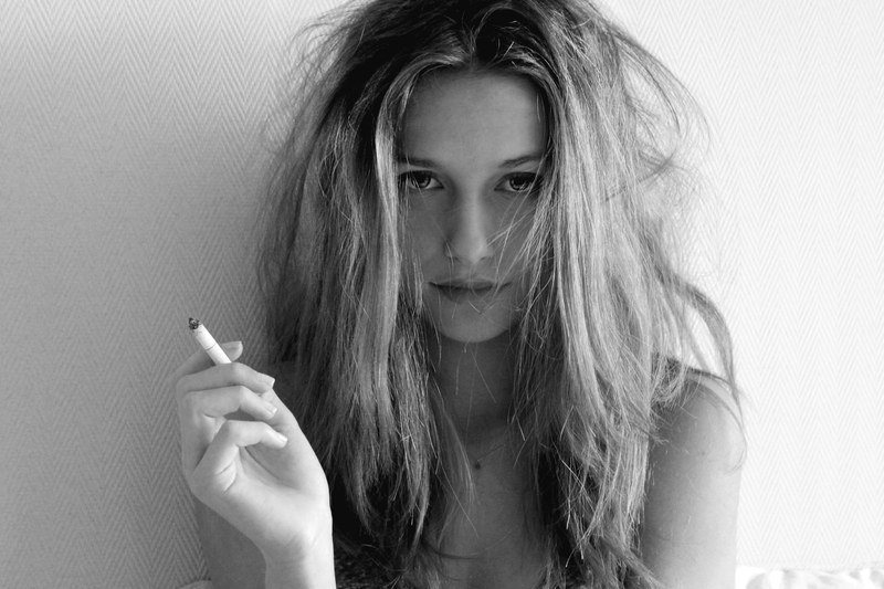 black and white shot of attractive blonde girl with messy hair with cigarette marseille, bampw 4k