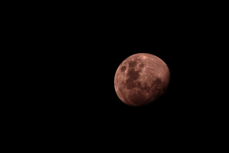the moon glowing red against the night sky, red moon on night sky 4k